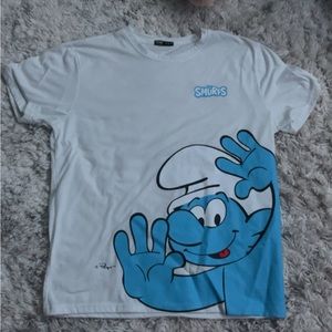 White t-shirt with The Smurf’s movie on front. Size- Large Brand- Romwe